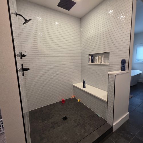 Full Shower Job with Arctic White Quartz, Trysta Bell-Ice Glass 2x6 (Walls with Frosty Grout), All Surfaces St Croix-Flint Mosaic (Pan with Raven Grout), Matte Black Metals, and Curve Drain
